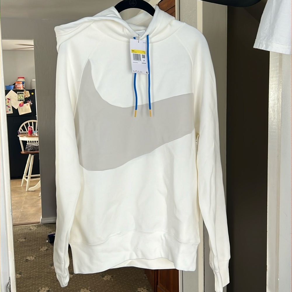 Niky white cream with a gray checkmark showing the registered mark on back